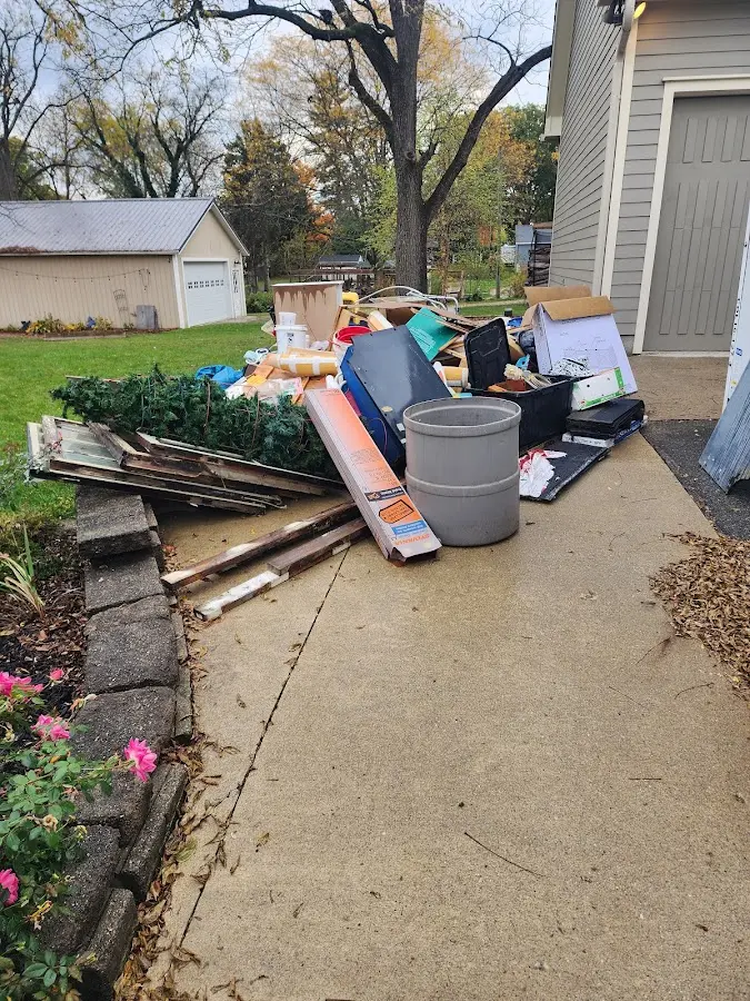Dumpster being loaded with debris for 10 Yard Dumpster Rental in Kingsland